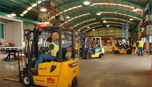 Forklifts operating in the Industrial Training School's warehouse