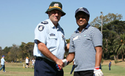 Police and student during a cricket match