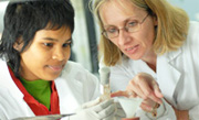 Student and teacher examining test tube