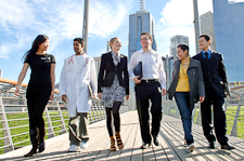 Six people depicting different professions walking across bridge at Birrarung Marr