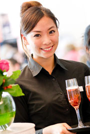 Smiling Student holding a Tray of Pink Champgane