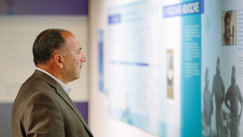  man studying an exhibit at the centenary exhibition 2016