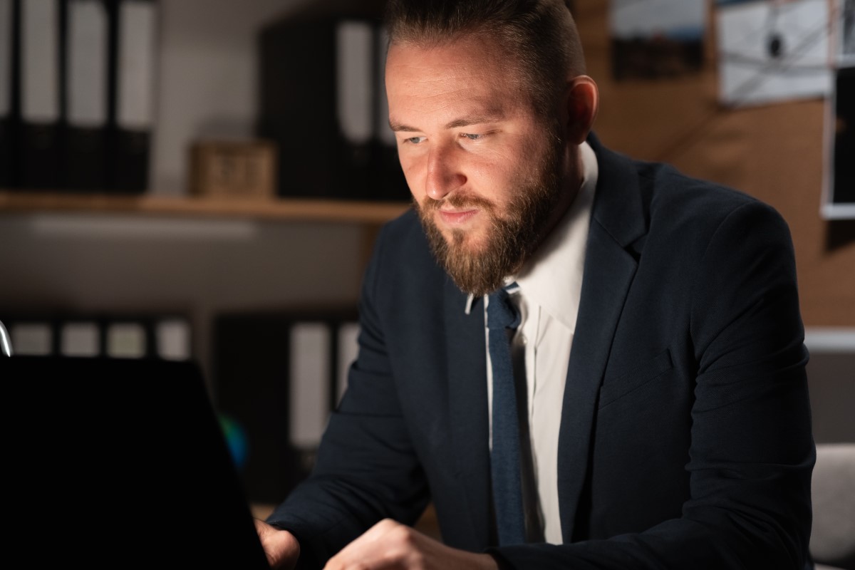  man working intently on a computer in his office