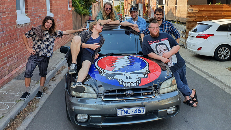 Deadnecks lounge on a skull-painted car
