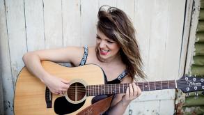 Emily Pritchard playing guitar outdoors