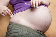 Pregnant woman preparing an injection