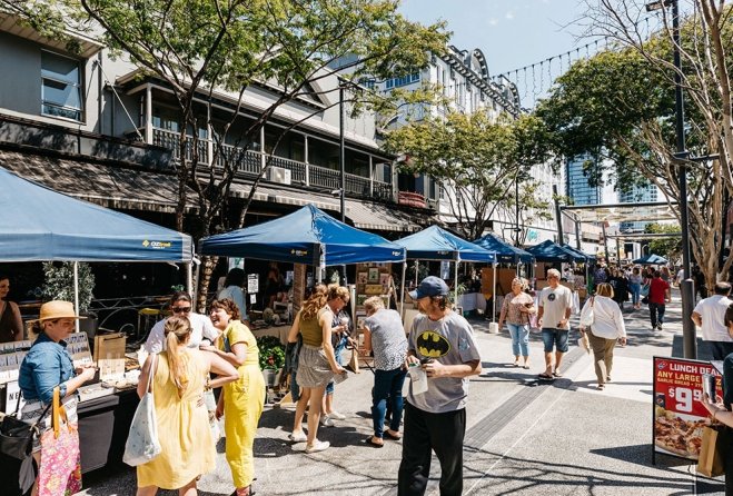  people mingling, walking through the Brunswick Market stalls in Fortitude Valley