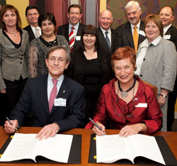 Andre Cointreau and VU Vice Chancellor Elizabeth Harman sign the agreement