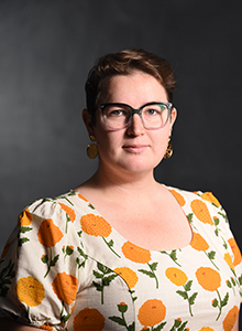 Portrait of a woman with glasses and a bright floral top