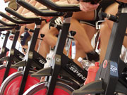 Students participate in a spinning class