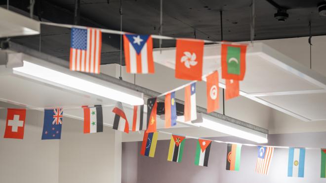 Our break room has a large variety of countries' flags hanging from the ceiling to recognise the diverse cultures that make up our university. A variety of different countries' flags hanging from the ceiling.