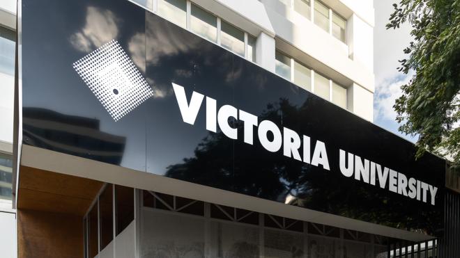 A large Victoria University outside a tall building