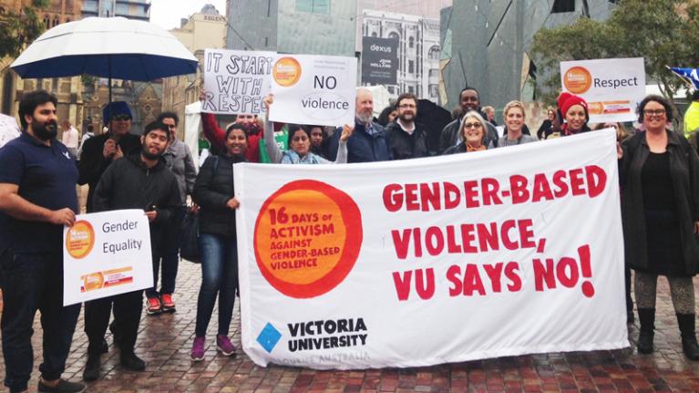 VU staff, students hold 'gender-based violence, VU says no!' sign