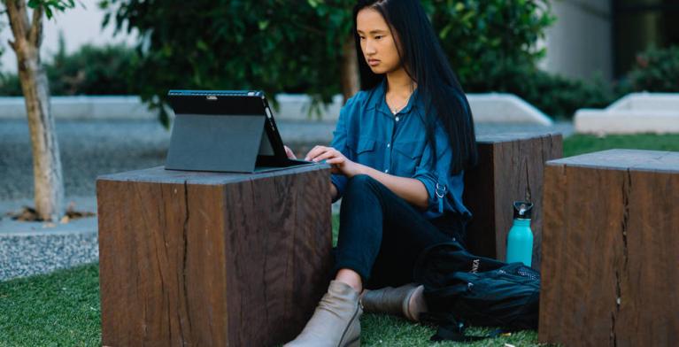 Student studying on tablet.