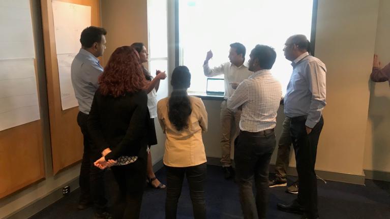 group of staff members in big room planning meeting