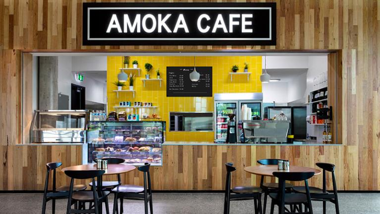 Amoka Café, which is indoors with tables and chairs at the front. 