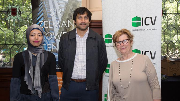 3 guest speakers standing in front of two banners (Sir Zelman Cowen Centre and Islamic Council of Victoria). They're smiling with closed mouths.