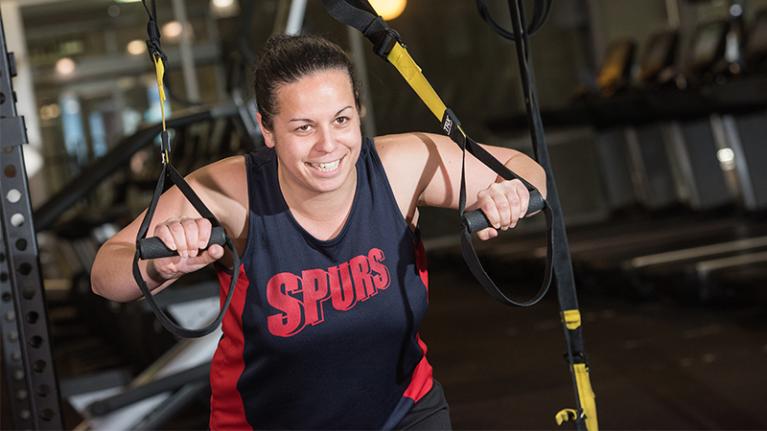 Female student working out in the gym.