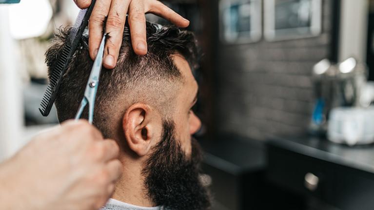  A barber cutting hair in a trendy barber shop