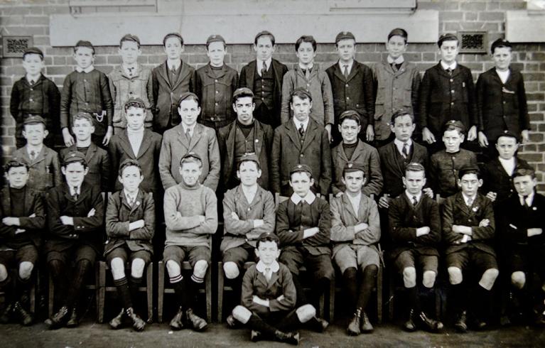 Black and white photo of young male students in suits