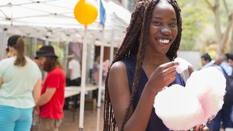  young woman eating fairyfloss at open day