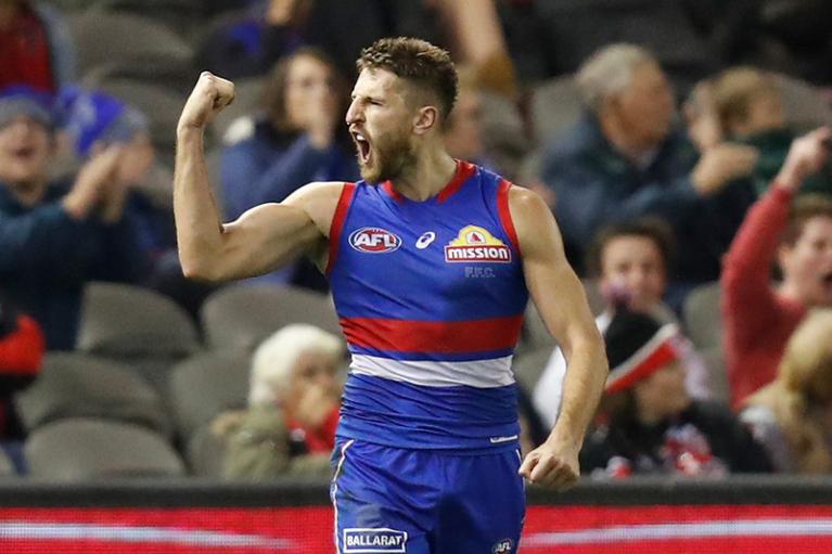 Bulldogs player raises a victory fist on the field