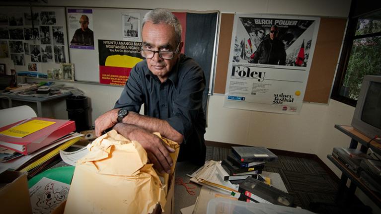 Gary Foley surrounded by items from the Aboriginal History Archive