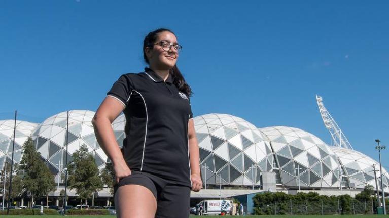 Katherin Sloan standing in front of AAMI Park.