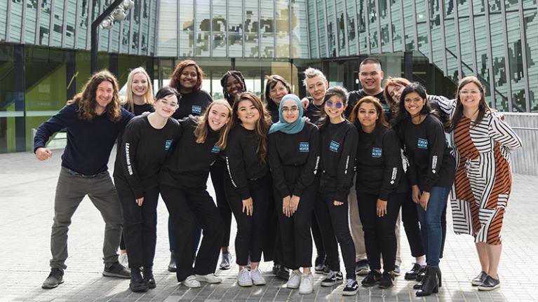 Group of student mentors smiling happily, on campus