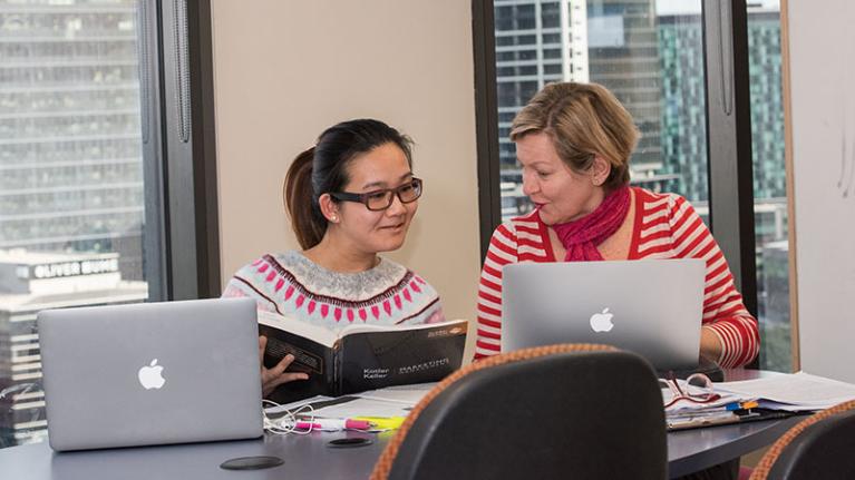 Two study buddies study together at City Flinders campus.