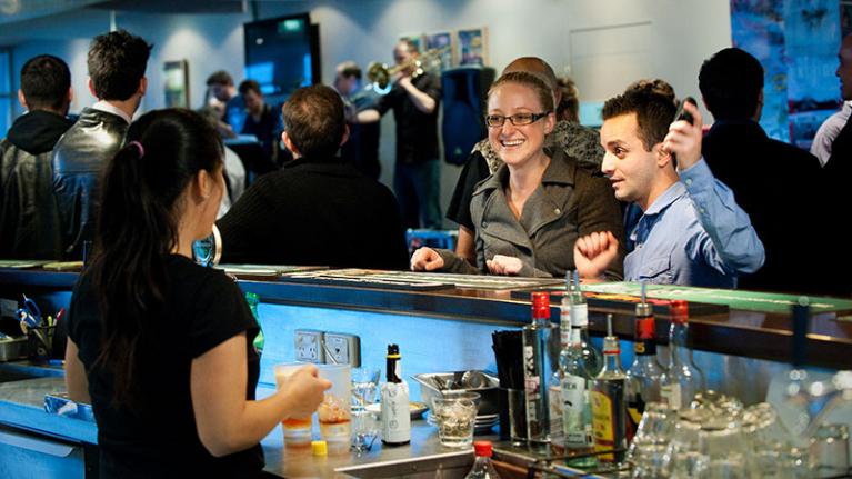 Students order drinks at VU Bar, on Footscray Park Campus