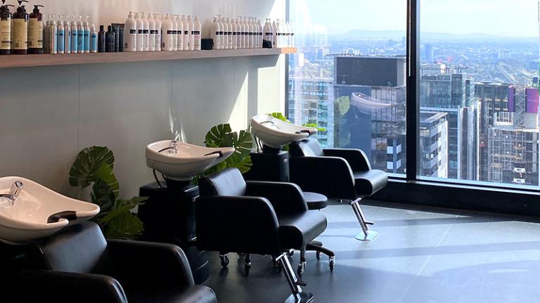 Inside the VU City Tower hair and beauty salon with city view.