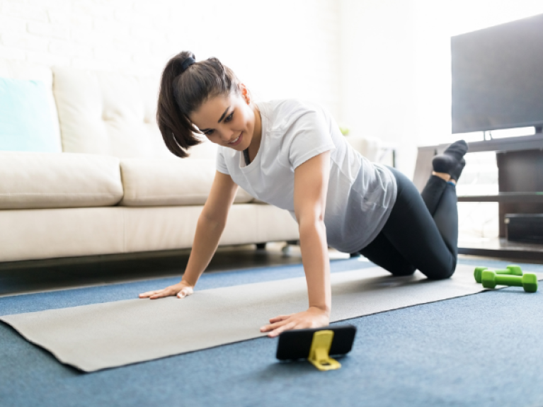  woman exercising on the floor of her lounge room