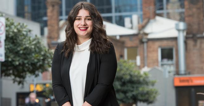 Young woman in modern, professional clothing in a trendy city environment