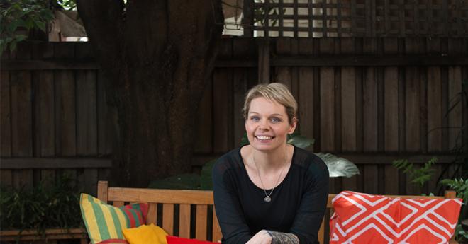 A woman smiles at the camera.