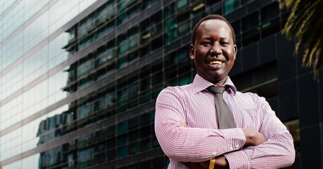 Man dressed professionally in front of city building