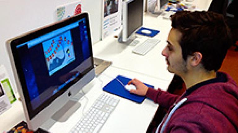  A graphics design student working at a computer.