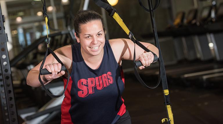  Female student working out in the gym.