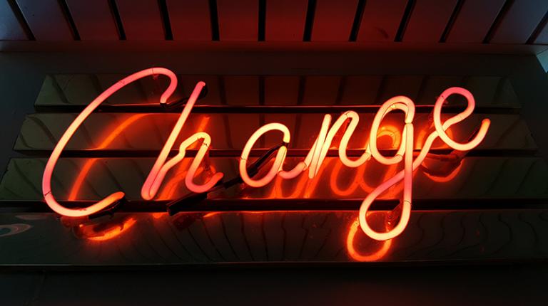  neon sign of the word change