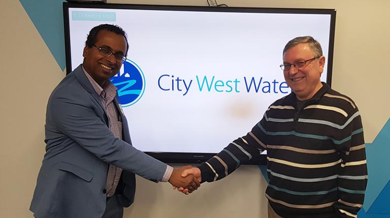 VU researcher shake hands with City West Water