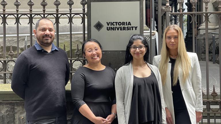 Miguel Valle Abrego (Bachelor of Laws, 3rd year), Melissa Kirby (Director Sharpe & Abel), Neeta Krishna Kumar and Theodora Petsas (Bachelor of Laws, 2nd year). Four law students stand outside VU campus.