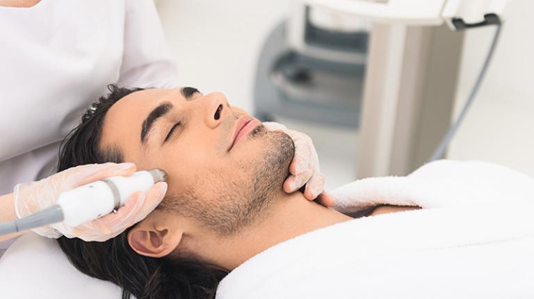  A dermal clinician performing a skin treatment on a client in the clinic.