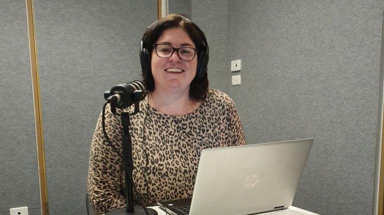 Law student Lisa Higgins podcasting her series, Coronavirus and the Law Lisa Higgins with her computer and microphone