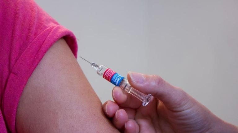 Person receiving a vaccine in their arm