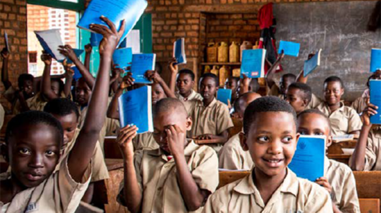 Source: UNICEF 2019, Burundi Adolescent Investment Case, Summary December 2019 Group of Afrtican school children, in class, wearing uniforms, smiling and holding books