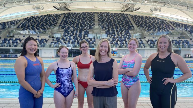 Professor Clare Hanlon and women from Swimming Victoria wearing their new and improved uniforms