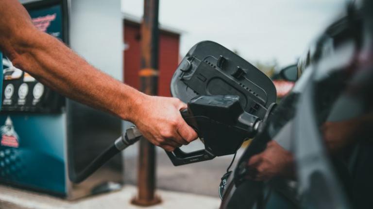 Male hand filling up car with petrol pump