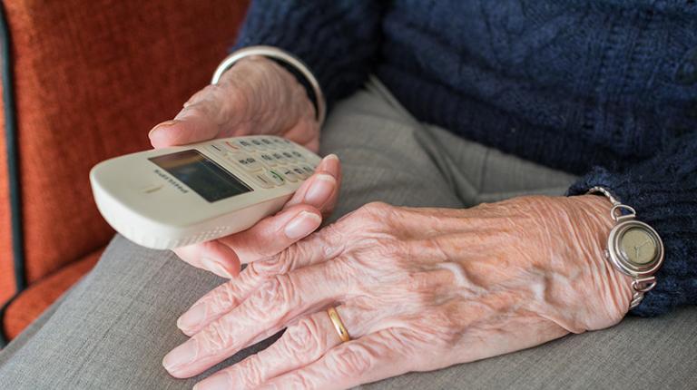 elderly hands hold phone 