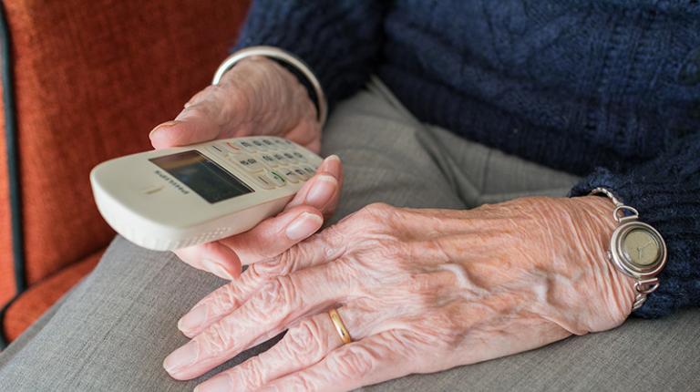 elderly hands hold phone