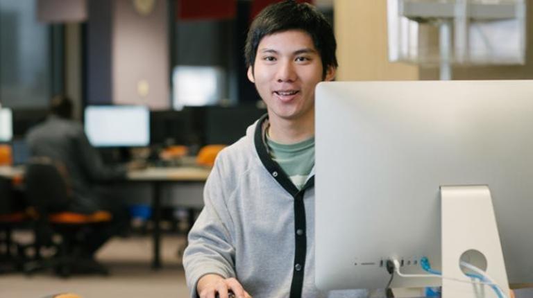 Student enrolling at computer